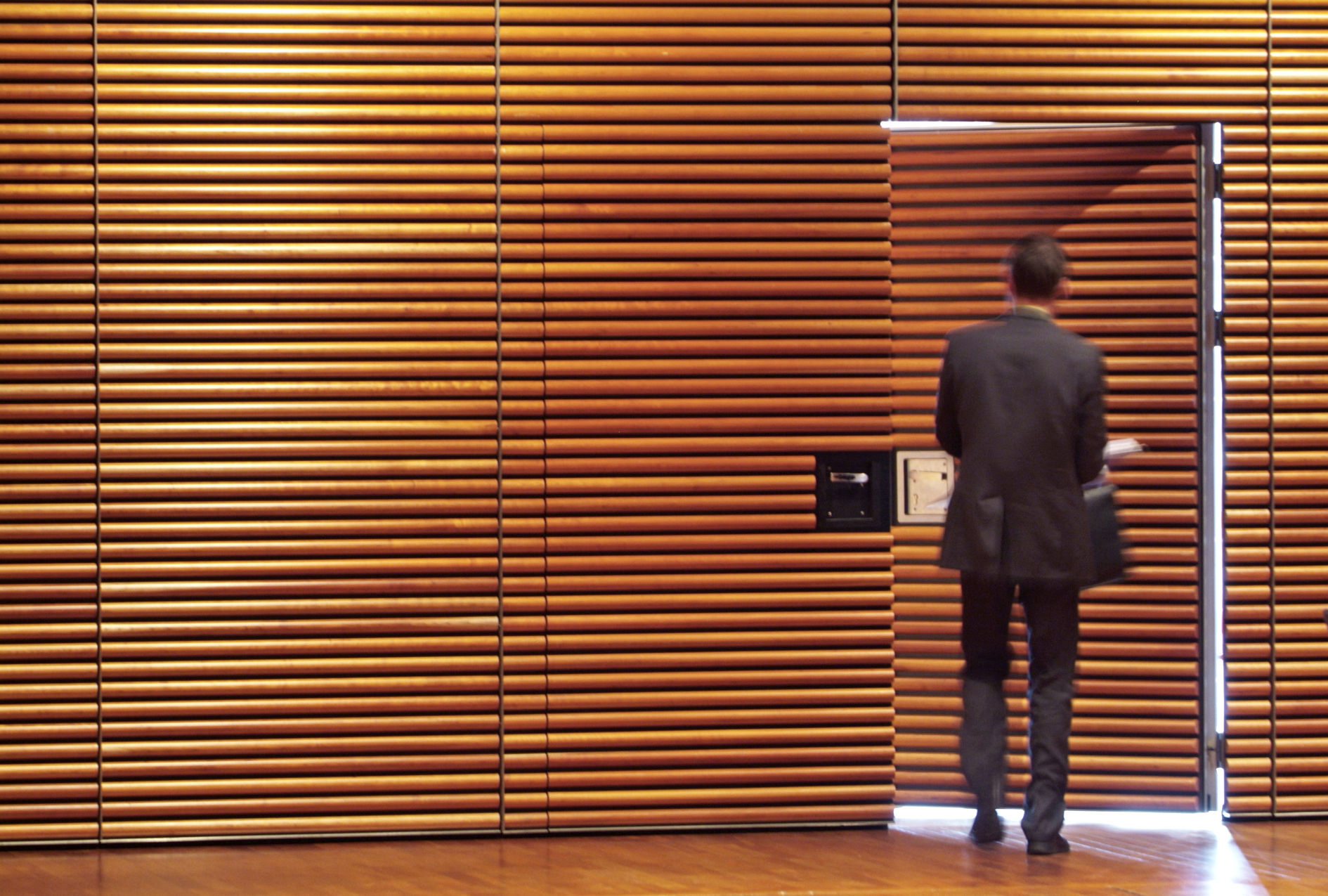 Man in suit walking through door