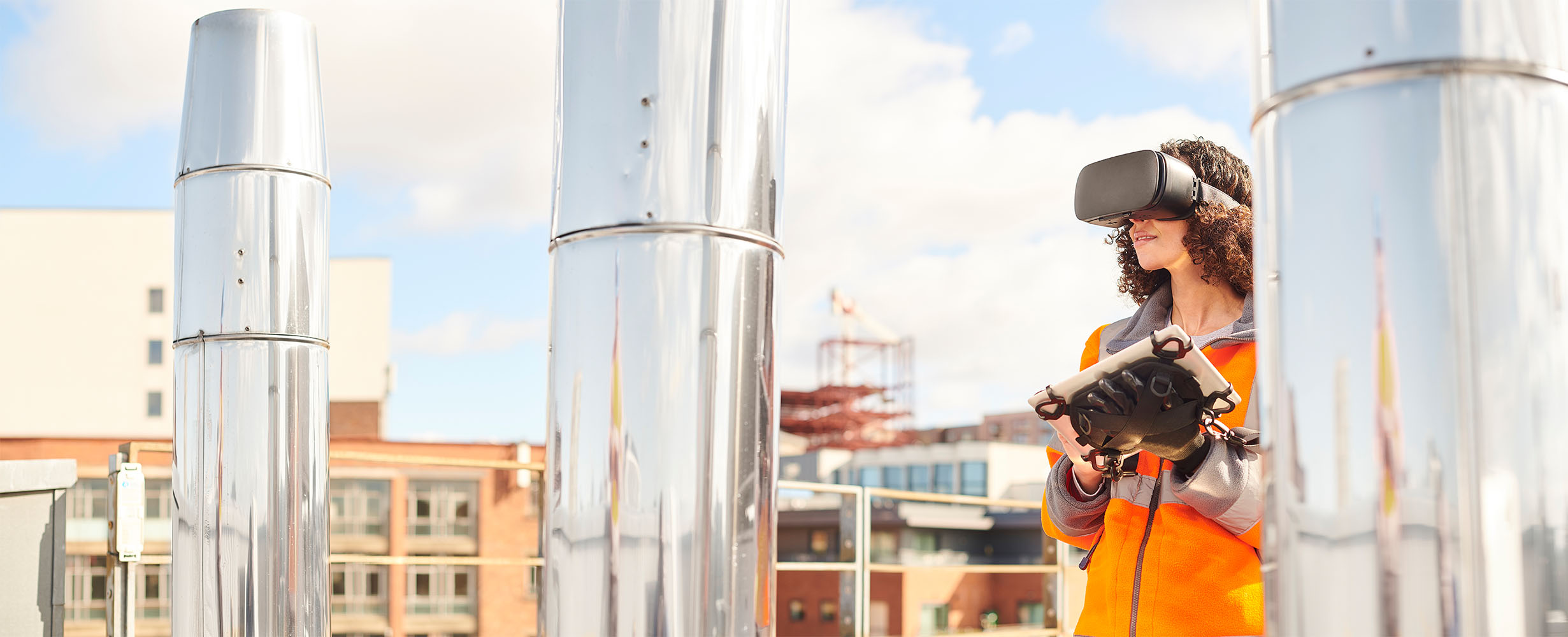 Female worker using VR headset and touch screen