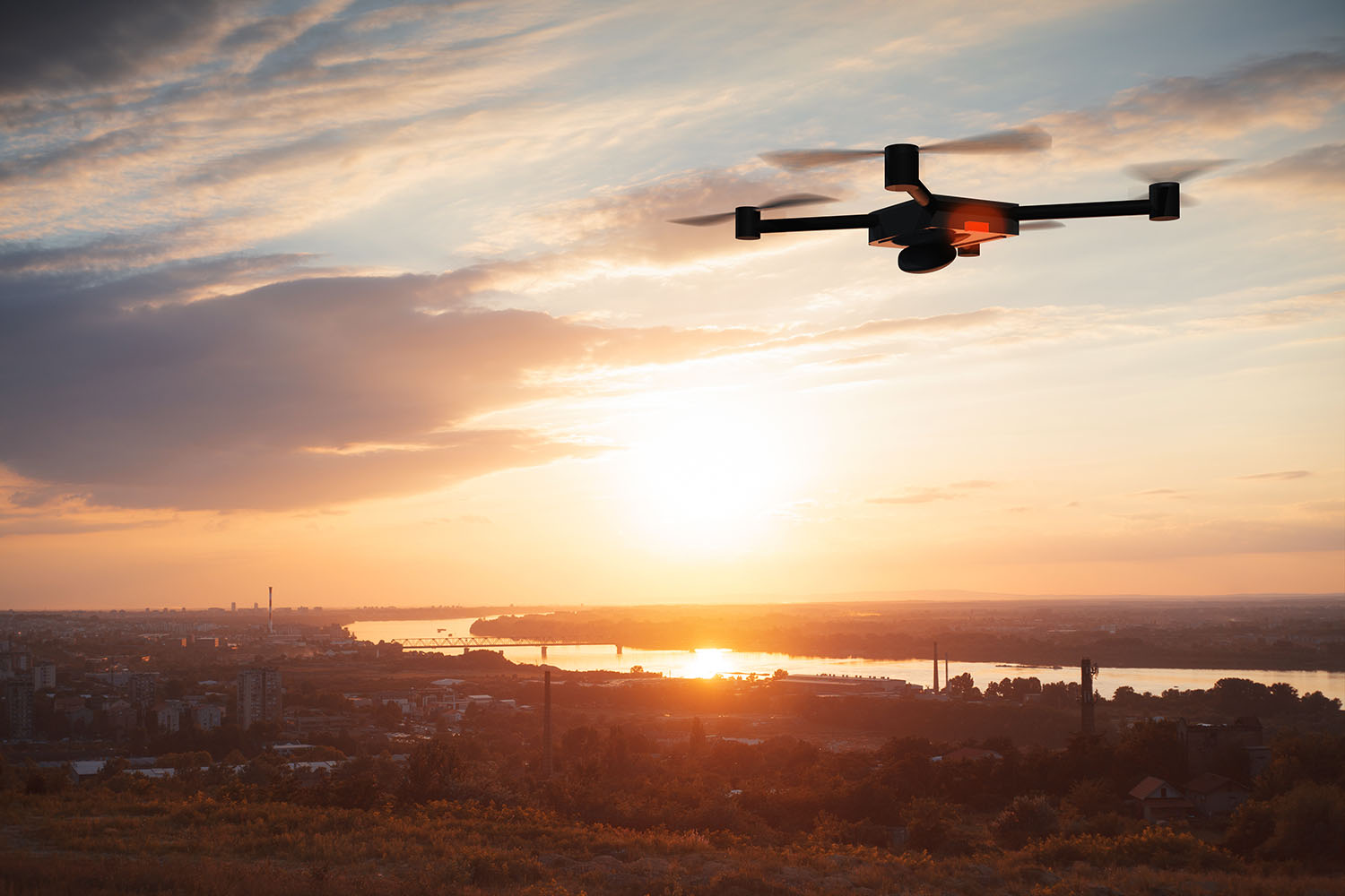 Small drone hovering over city