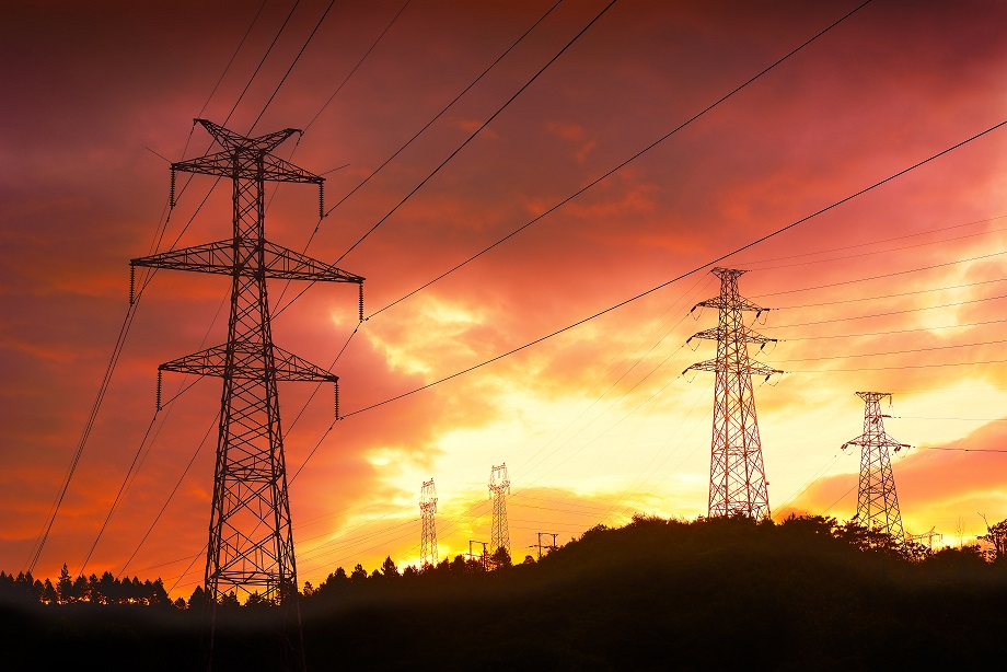 Electricity pylons, sunset background