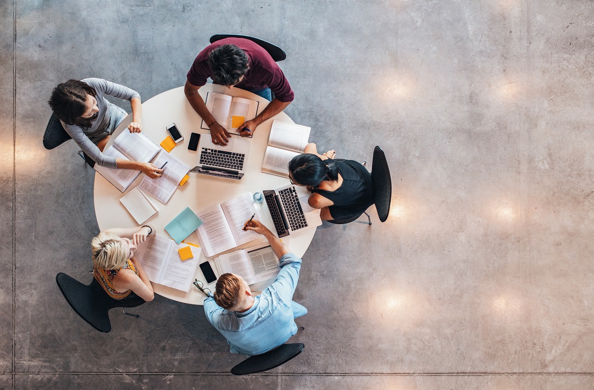 Above view of people in a meeting sitting around a table