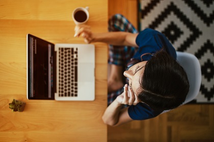 Above view of a person working on their laptop, from home