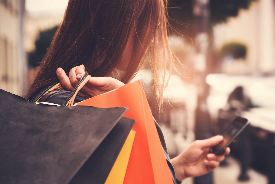 Woman carrying shopping bags on her shoulder