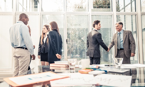 People in a business meeting, shaking hands