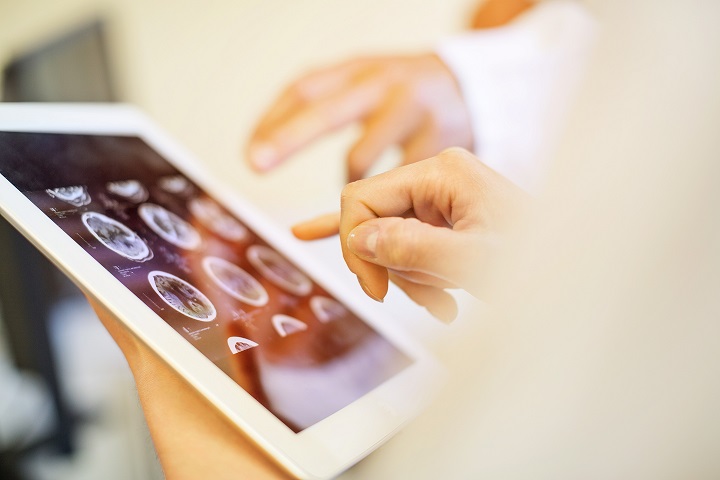 People viewing x-rays on a tablet screen