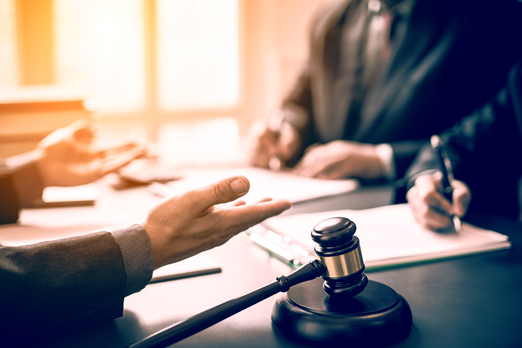 People in a meeting and close up of a gavel