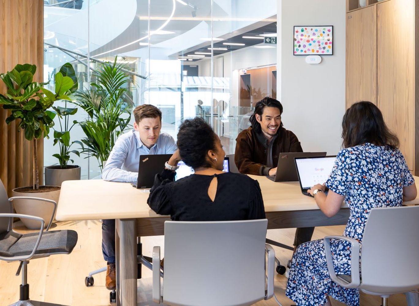 four employees meeting in a flexible working space