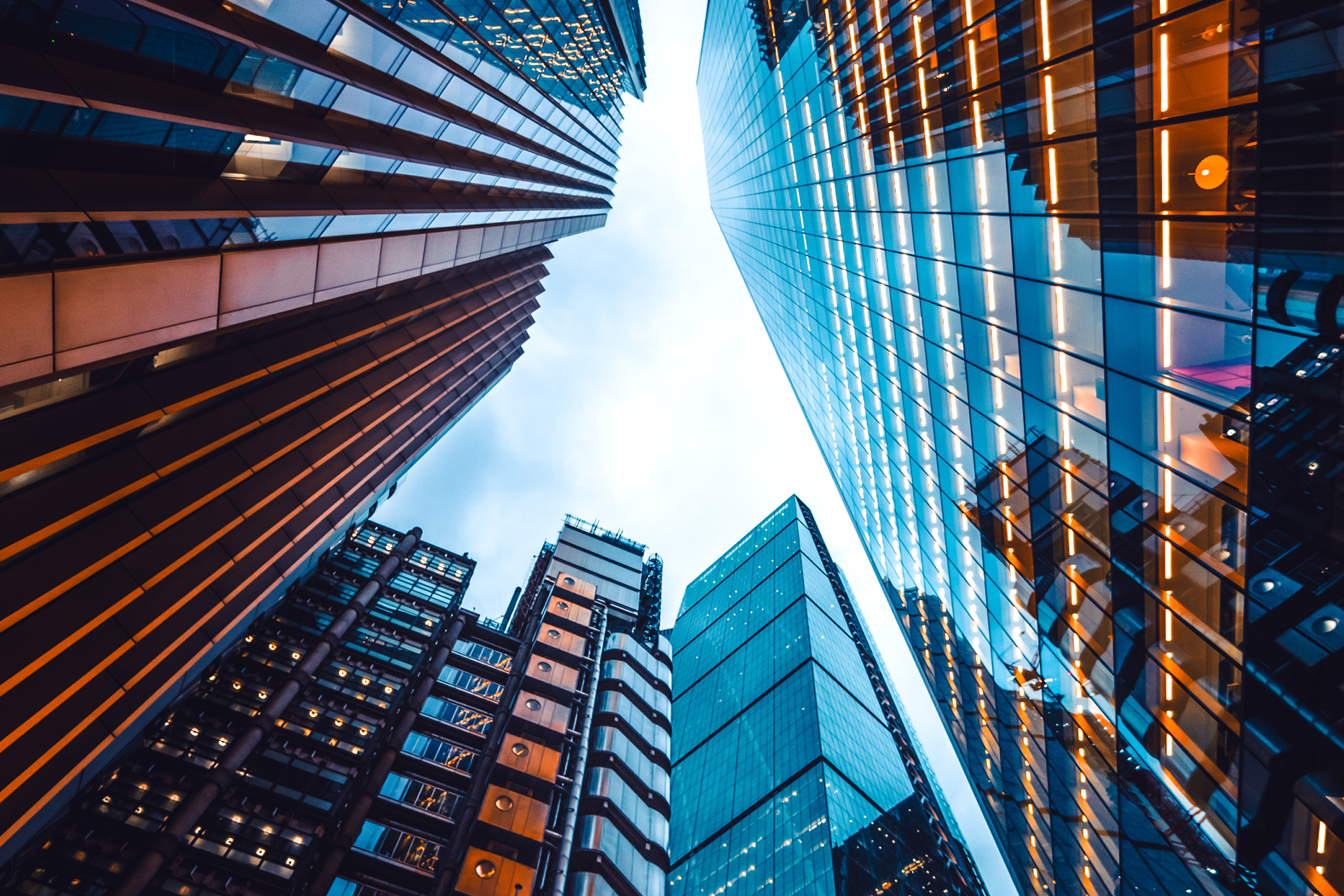 Looking up at the sky through a gap in skyscrapers
