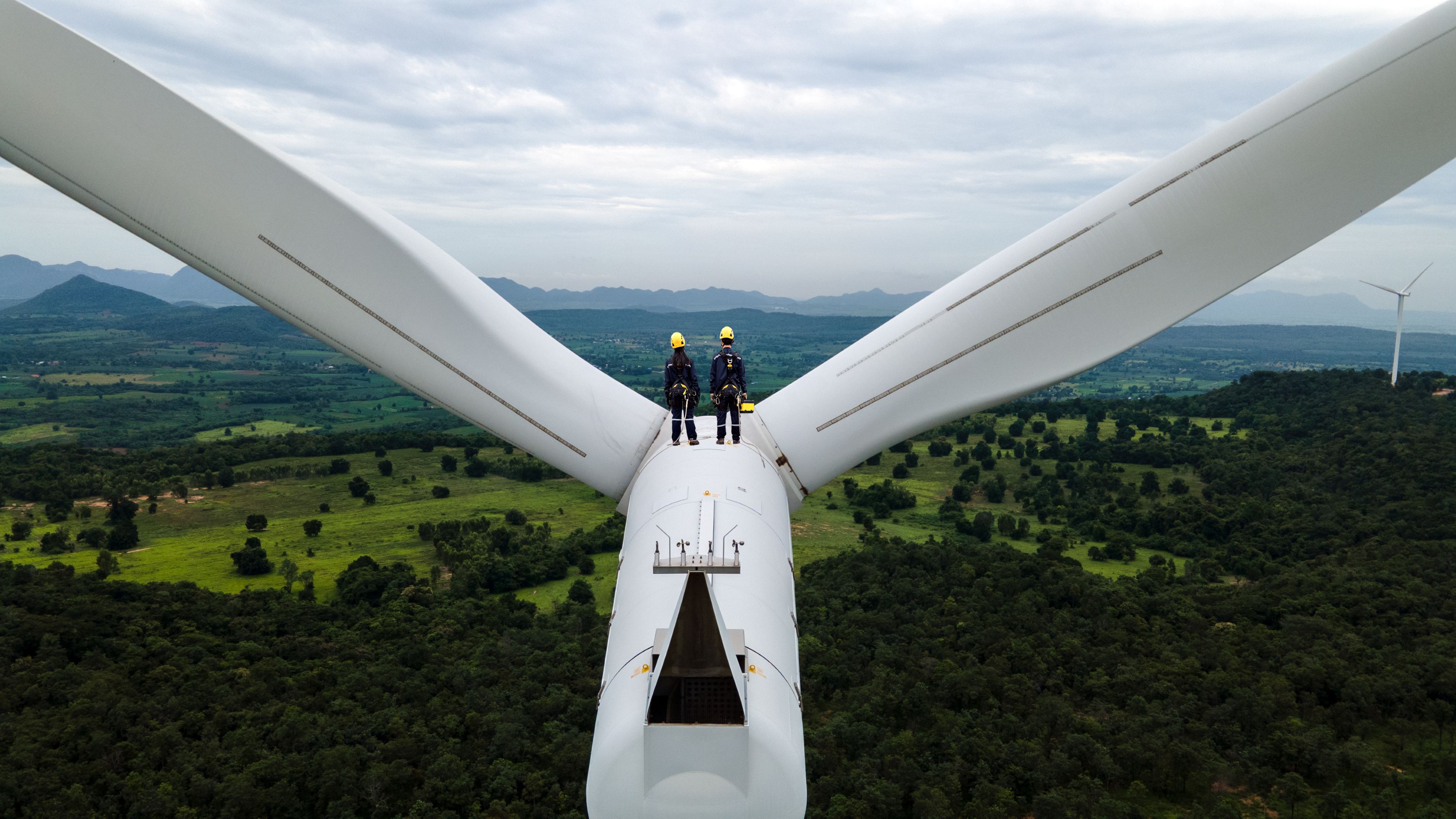 People stood on a wind turbine